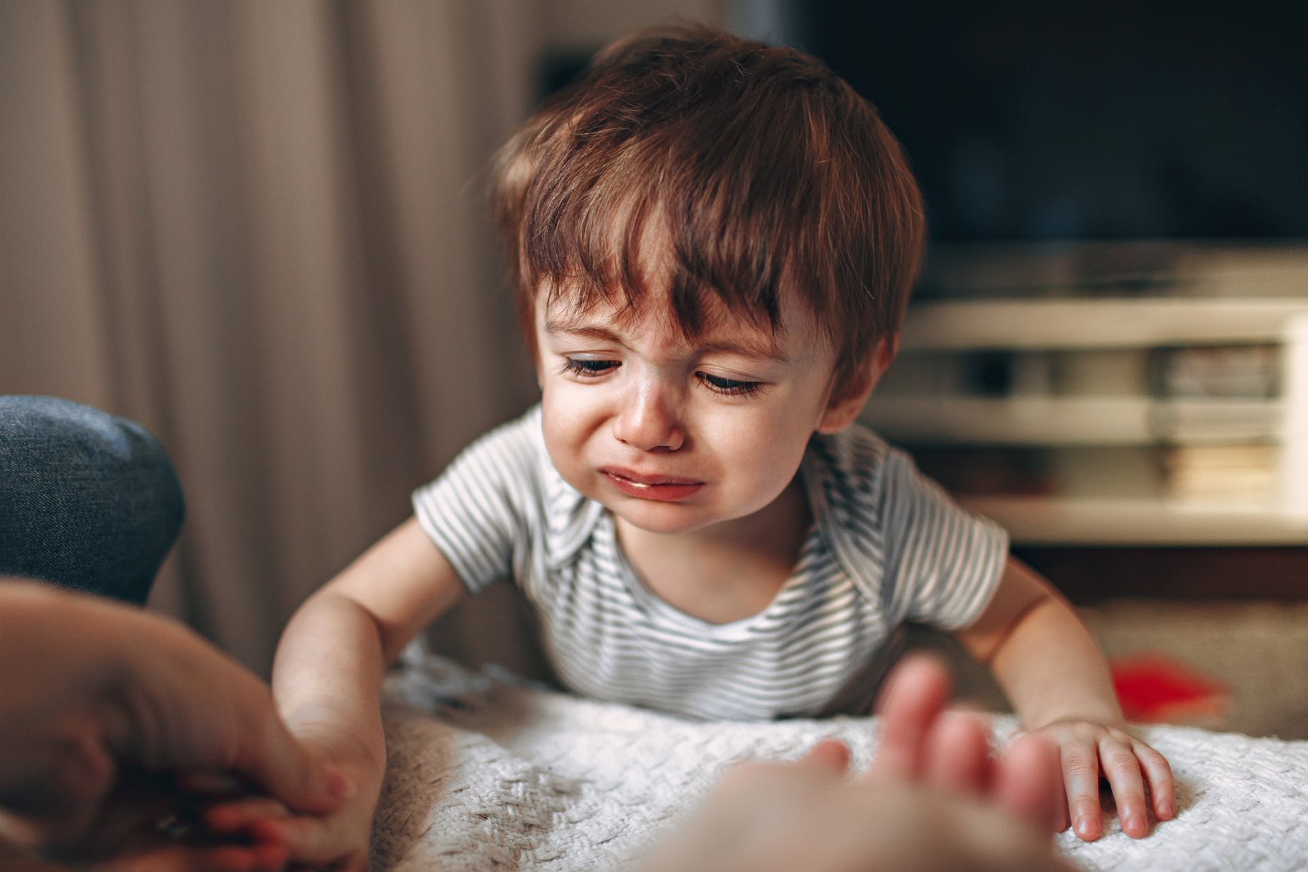 selective focus photo of a kid crying